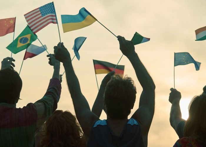 International protest rally outdoors. Interracial party. Evening sky background.